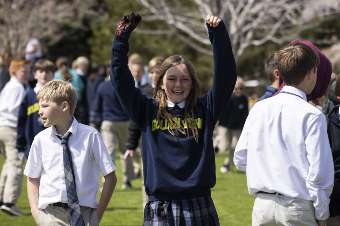 Middle school student cheers in celebration.